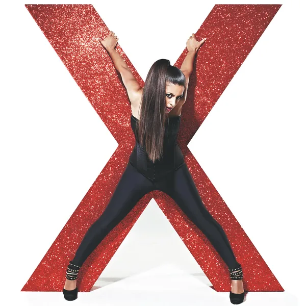 Konnie Huq posing with a giant red glitter X