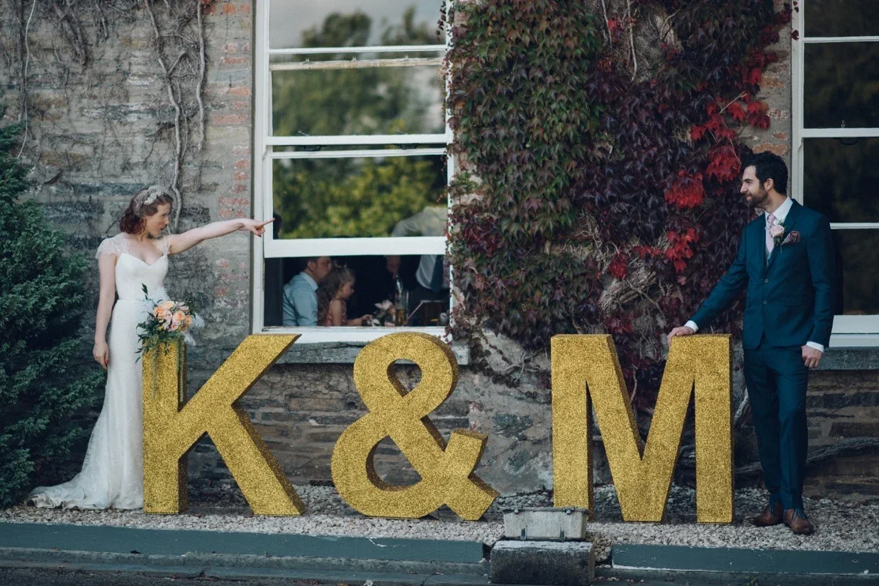 Gold glitter wedding letters with a bride and groom